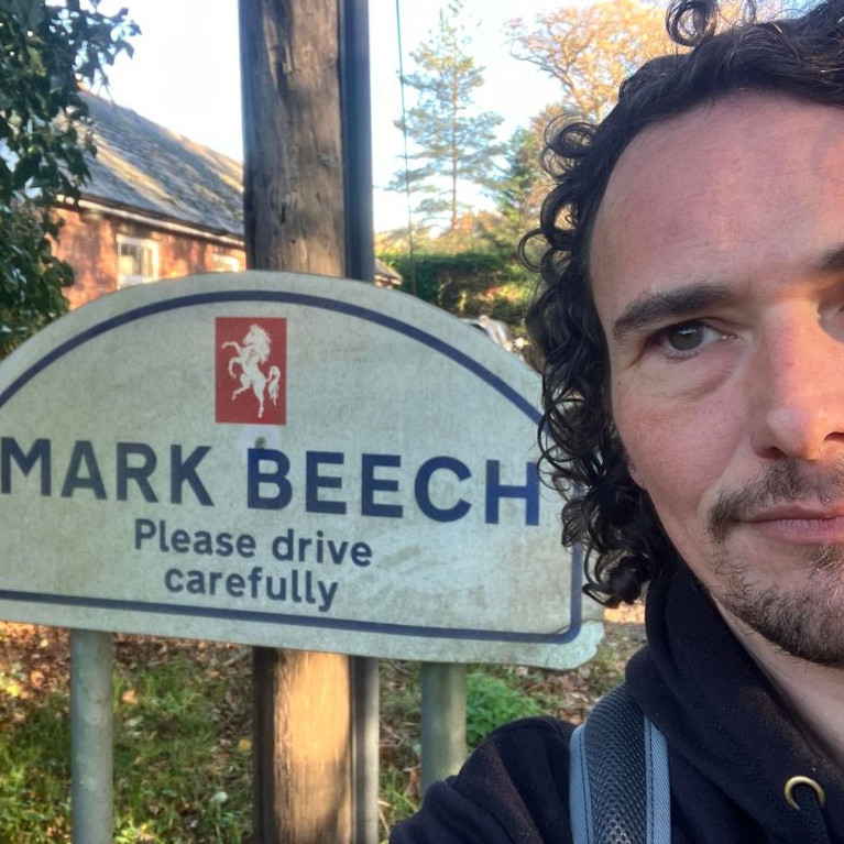 Selife of Mark Beech, in the village of Mark Beech - with a road sign telling one to drive with care.